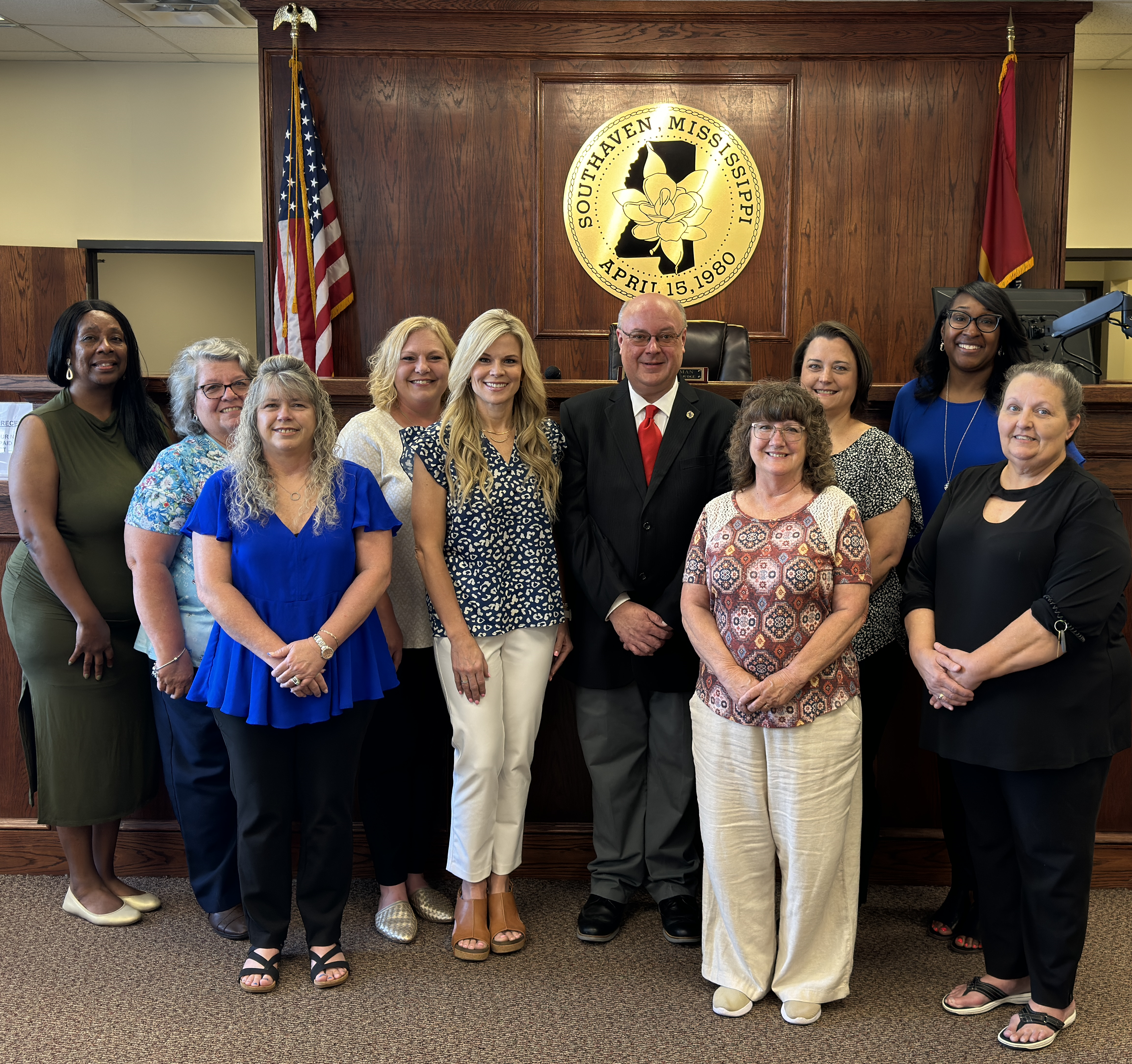 Court staff standing in court smiling at camera
